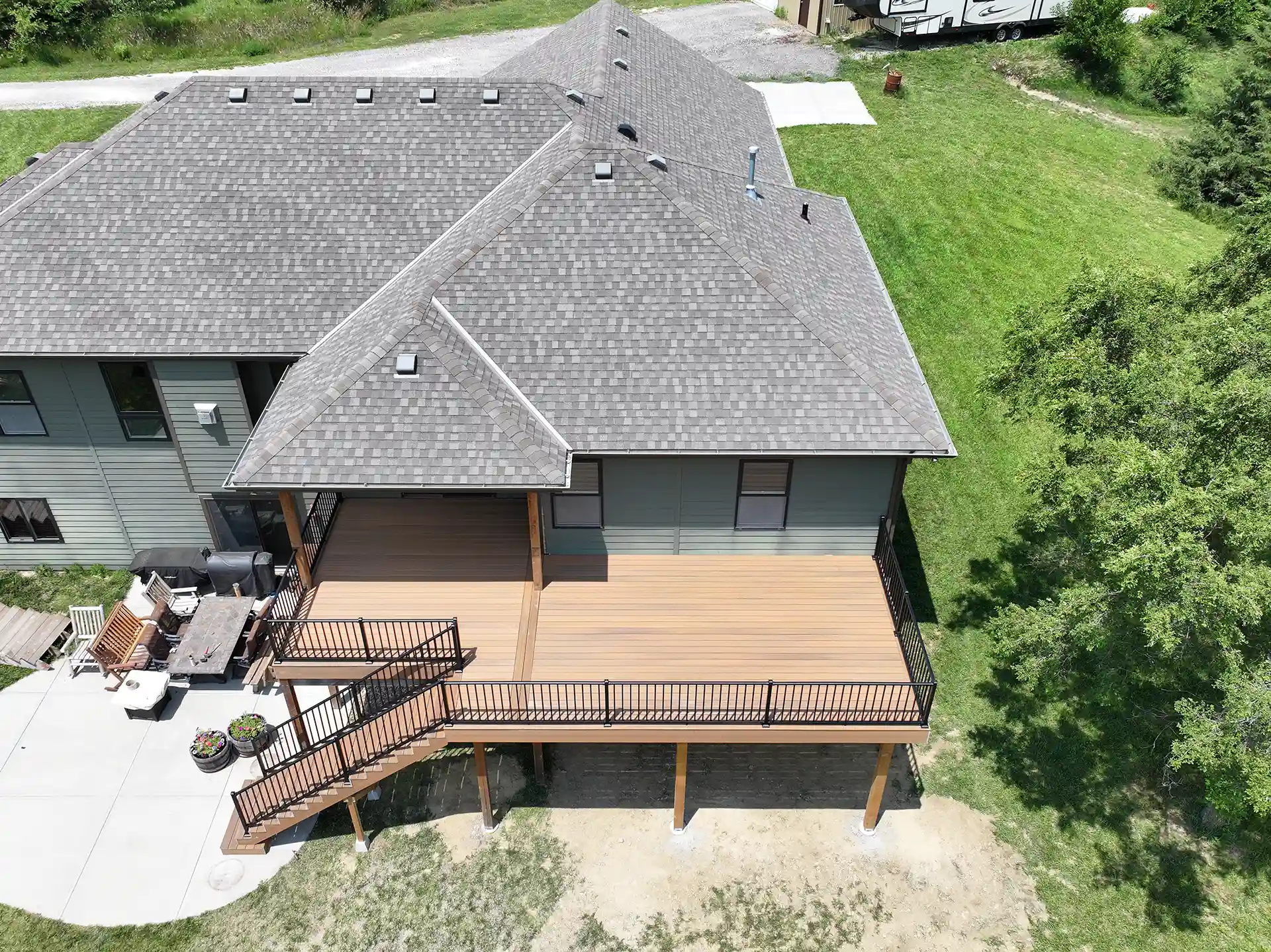 aerial view of an elevated deck with patio - Deck Planning for Spring - Finding the best deck contractor near me