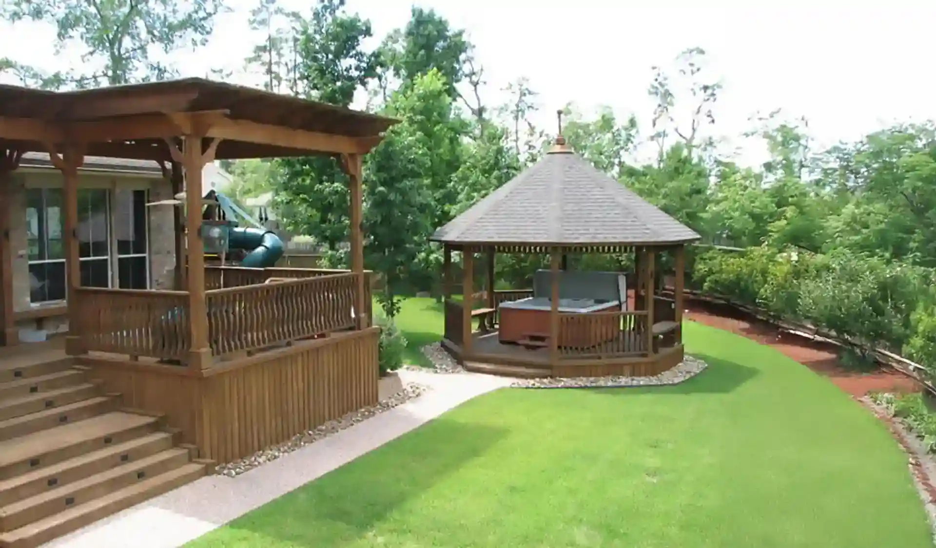 raised deck with a wooden pergola and freestanding gazebo - What is a gazebo - pergola vs gazebo​ comparison