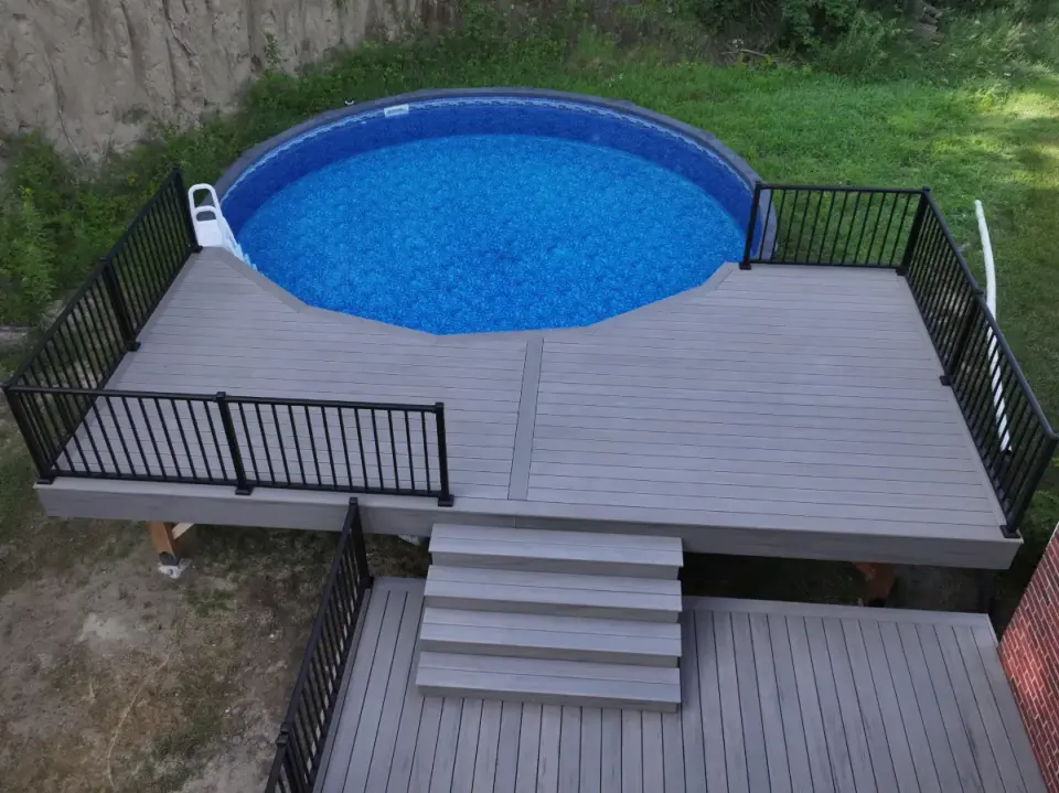 residential-pool-deck-stairs-with-black-metal-railing-and-a-pool-in-omaha-ne
